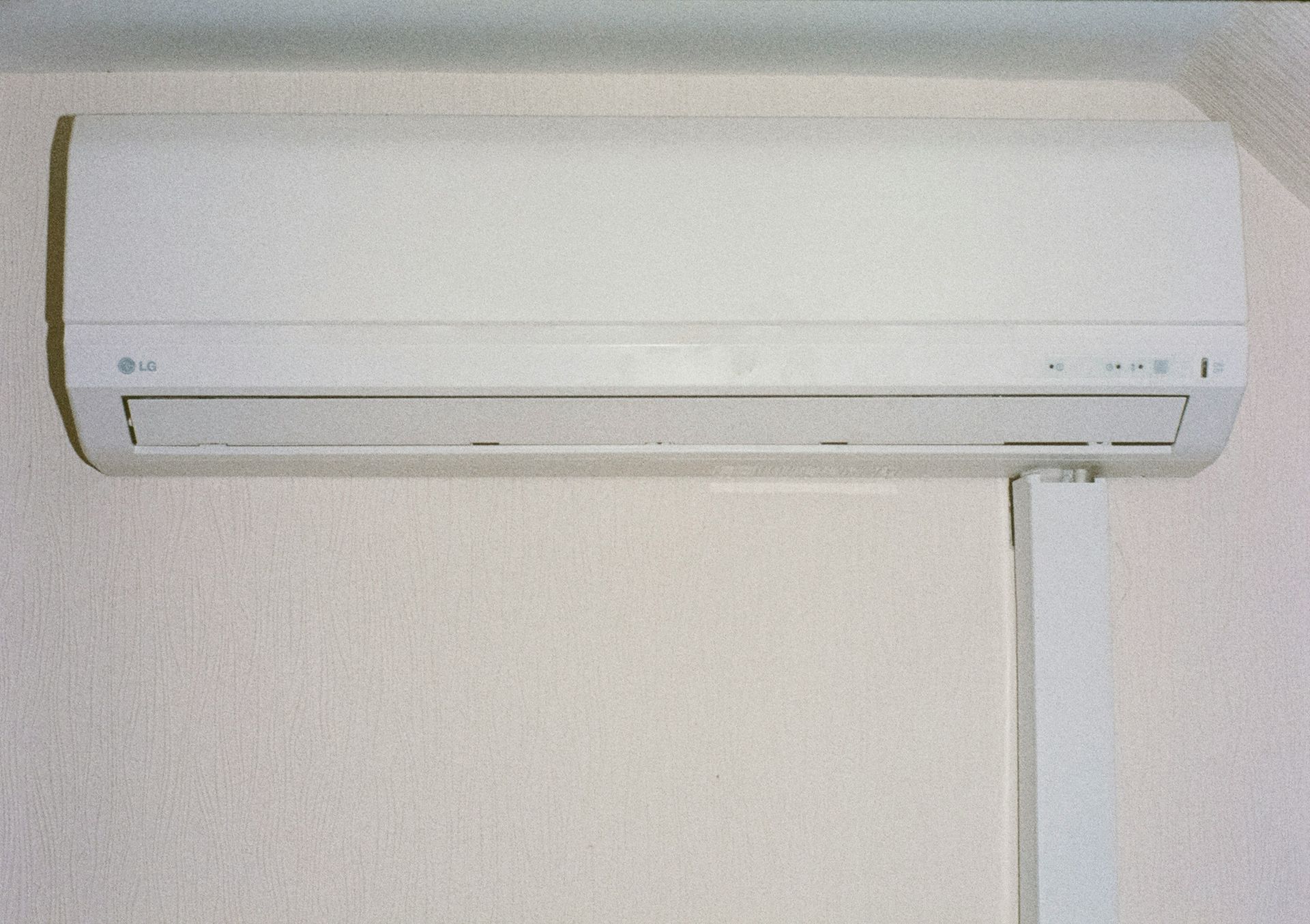 A white air conditioner mounted on a wall